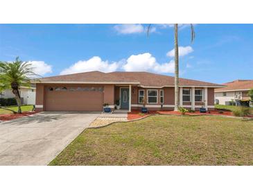 Charming single-story home boasts a well-manicured lawn, mature landscaping, and inviting curb appeal at 5246 Montserrat Dr, Lakeland, FL 33812