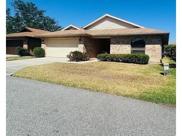 Charming single-story brick home with well-maintained landscaping and a two-car garage at 668 Jamaica Cir, Lakeland, FL 33803