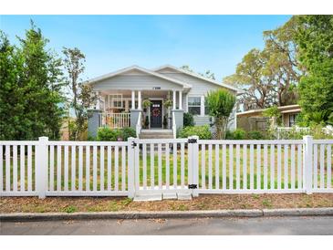 Charming home featuring a white picket fence and a welcoming front porch at 807 Osceola St, Lakeland, FL 33801