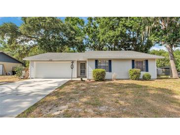 Charming single-story home with a well-maintained lawn and attached two-car garage at 819 Swann Dr, Lakeland, FL 33809