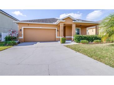 Charming single-story home with a two-car garage, well-maintained lawn, and inviting curb appeal at 983 Revere Ave, Haines City, FL 33844