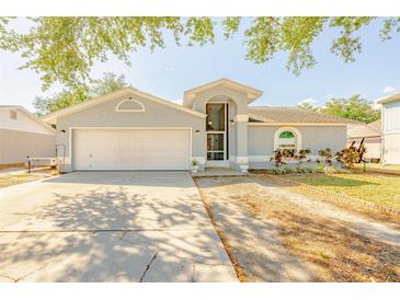 Charming single-story home with a well-maintained lawn and a two-car garage, perfect for a Gathering at 1061 Lowry Ave, Lakeland, FL 33801