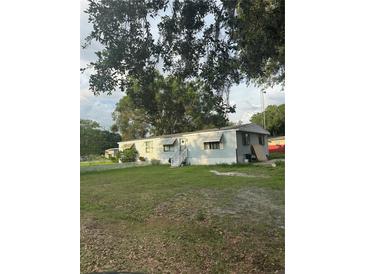 Charming single-story home with a well-maintained front yard and welcoming entryway with steps at 2621 Island Oaks W, Lakeland, FL 33805