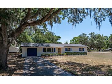 Charming single-story home with fresh exterior paint, shutters, a new roof and a paved driveway at 3705 Garland St, Mulberry, FL 33860