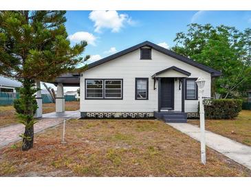 Charming white and dark gray bungalow with well-kept lawn and inviting front entrance at 522 Channing Rd, Lakeland, FL 33805