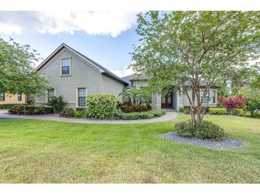Landscaped front yard featuring lush lawn, stone walkway, and mature trees creating an inviting curb appeal at 6347 Ashley Dr, Lakeland, FL 33813