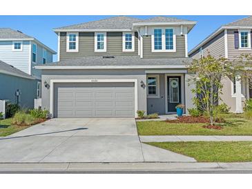 Two-story home with a gray exterior, well-maintained landscaping, and a two-car garage at 6520 Great Bear Dr, Lakeland, FL 33805