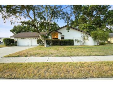 Charming single-story home featuring a well-manicured lawn and an attached two-car garage at 781 Bryson Loop, Lakeland, FL 33809