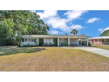 Charming single-story home with a carport and mature landscaping in a quiet neighborhood at 118 Lake Sears Dr, Winter Haven, FL 33880