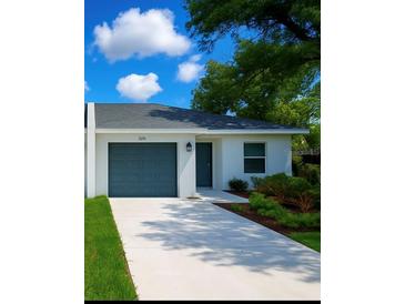 Charming single-story home with a well-manicured lawn and a driveway leading to an attached garage at 1251 Dosseywood Ln, Lakeland, FL 33811