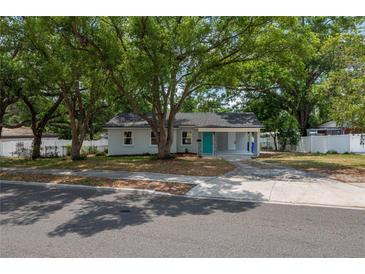 Charming single-story home featuring a well-manicured lawn and inviting curb appeal with mature trees at 315 Eastway Dr, Lakeland, FL 33803