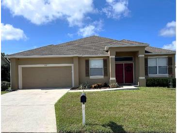 Charming one-story home boasts a well-manicured lawn and a two-car garage at 4041 Byrds Crossing Dr, Lakeland, FL 33812