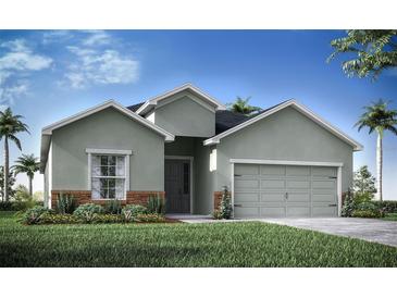 Charming single-Gathering home with a gray exterior, landscaped front yard, and attached two-car garage at 7562 Sw 108Th St, Ocala, FL 24476