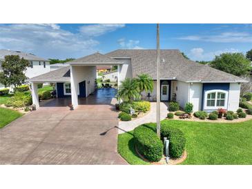 Charming home with a well-manicured lawn, a covered driveway, and inviting curb appeal at 1056 Rally Dr, Polk City, FL 33868