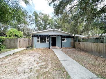 Charming single-story home featuring a symmetrical facade, a welcoming entryway, and a well-maintained wooden fence at 1160 Austin St, Bartow, FL 33830