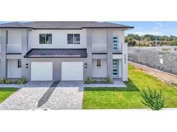 New construction with modern design, two-car garage, and manicured landscaping for a stylish home at 1171 Windjammer Dr, Lakeland, FL 33803