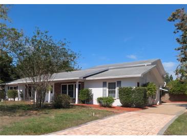 Charming single-story home with well-maintained landscaping and a brick-paved driveway leading to the entrance at 16 Golfview Ne Cir, Winter Haven, FL 33881