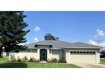 Charming one-story home featuring a well-maintained lawn and a two-car garage at 200 S Goodman Ave, Lake Alfred, FL 33850