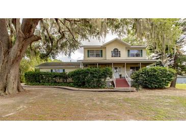 Charming two-story home with a covered porch and mature trees in a peaceful setting at 330 W Palmetto St, Lakeland, FL 33815