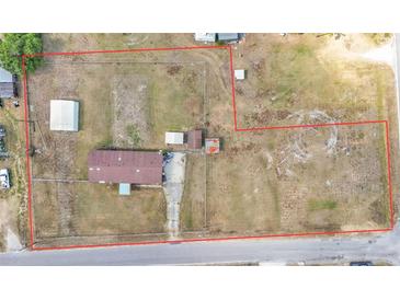 Sprawling property featuring a mobile home, outbuildings, and extensive fenced yard space from an aerial view at 4207 Ollie Rd, Lakeland, FL 33810