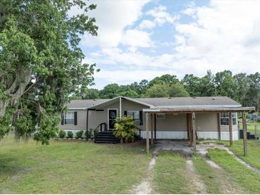Charming single story home with a covered entrance and a matching covered carport at 5339 Meadow Grove Trl, Lakeland, FL 33810