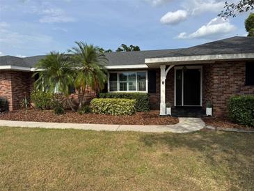 Charming single-story brick home with well-maintained landscaping, enhancing its curb appeal at 5604 Stratford Ln, Lakeland, FL 33813