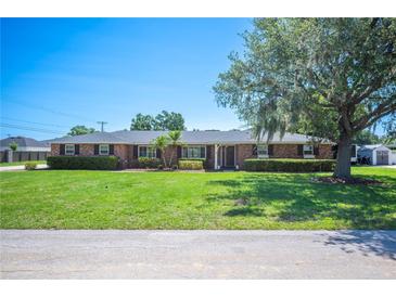 Charming single-story brick home with mature trees, manicured lawn, and classic curb appeal at 5604 Stratford Ln, Lakeland, FL 33813