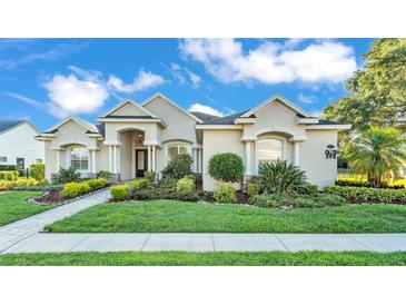 Charming single-story home featuring a beautifully landscaped yard and welcoming front entrance with classic architectural details at 6546 Eagle View Loop, Lakeland, FL 33813