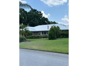 Charming single-story home with a well-manicured lawn and a neatly arranged landscape at 1110 Cypress W Pt, Winter Haven, FL 33884