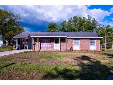 Charming single-story brick home featuring a well-maintained lawn and inviting carport at 1160 Eleanore Ave, Bartow, FL 33830