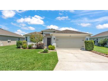 Charming single-story home with a well-manicured lawn and an attached two-car garage at 1215 Evergreen Park Cir, Lakeland, FL 33813