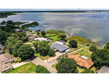 Stunning aerial view of the waterfront home with lush landscaping and private dock at 1328 Edgewater Beach Dr, Lakeland, FL 33805