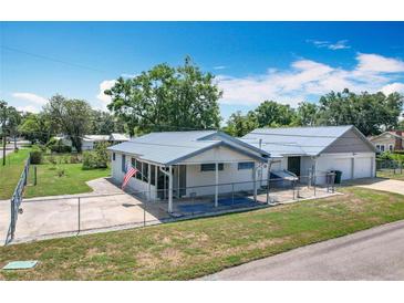 Charming single-story home with a metal roof, fenced yard and screened porch at 1405 Clinton St, Bartow, FL 33830