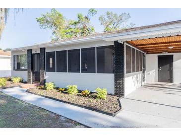 Charming single-story home featuring a screened porch and fresh landscaping at 1507 Holly Rd, Lakeland, FL 33801