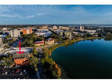 Aerial view of a brick building on a lake in the middle of a city at 200 Lake Morton Dr # 100, Lakeland, FL 33801