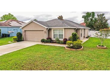 Charming single-Gathering home featuring well-maintained landscaping and a two-car garage at 2040 Chickadee St, Bartow, FL 33830
