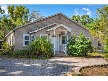 Charming single-story home featuring a welcoming front porch and well-maintained landscaping at 402 W Patterson St, Lakeland, FL 33803