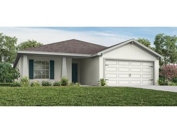 Charming single-story home featuring a two-car garage, a quaint front porch, and tasteful landscaping at 702 Bentley North Loop, Auburndale, FL 33823