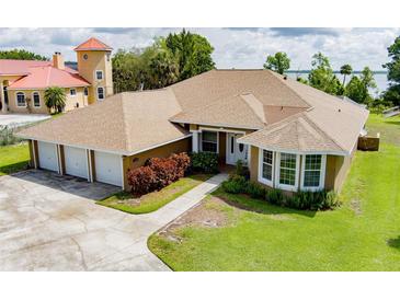 Lovely single-story home with a well-manicured lawn and three-car garage, offering ample space and curb appeal at 9093 S Bay Dr, Haines City, FL 33844