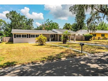 Charming single-story home with a carport and front yard featuring palm trees at 960 Lila St, Bartow, FL 33830