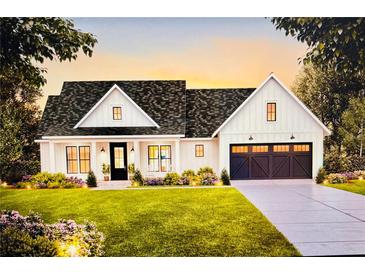 Charming new construction home with white siding, black accents, and a well-manicured lawn at 0 Walt Williams Rd, Lakeland, FL 33809