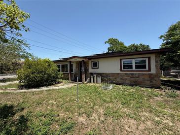 Charming single-story home featuring stone accents and a cozy front yard at 1208 Lowry Ave, Haines City, FL 33844