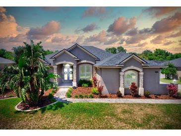 Charming single Gathering home featuring a beautiful, manicured lawn and mature landscaping at 2032 Indian Sky Cir, Lakeland, FL 33813