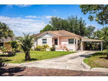 Charming single-story home with a carport, front porch and well maintained lawn at 2710 Fairmount Ave, Lakeland, FL 33803