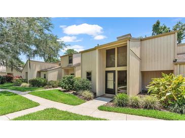 Inviting two-story home with beautiful landscaping and a charming front porch at 30 Aspen Dr # 30, Haines City, FL 33844