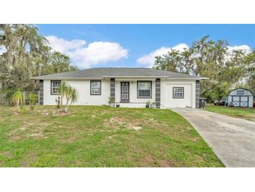 Charming single-story home with well-maintained lawn and complementary landscaping at 306 Olmo Ct, Winter Haven, FL 33880