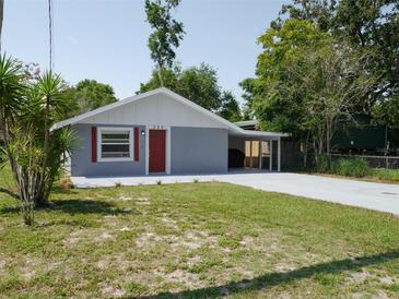 Charming single-story home with a well-maintained lawn and a covered parking area at 355 E Columbia St, Lake Alfred, FL 33850