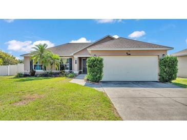 Charming single-story home with a well-manicured lawn and attached two-car garage at 555 Heather Glen Dr, Winter Haven, FL 33884