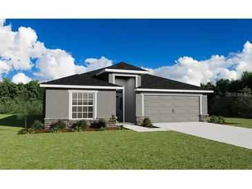 Charming single-Gathering home boasting a well-manicured lawn and a two-car garage at 1420 Portmore Dr, Mulberry, FL 33860