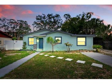Charming single-story home featuring a manicured lawn and stepping stone walkway at 1648 Skinner St, Lakeland, FL 33801